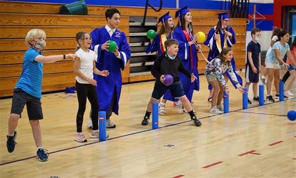 Students play dodgeball in the gym